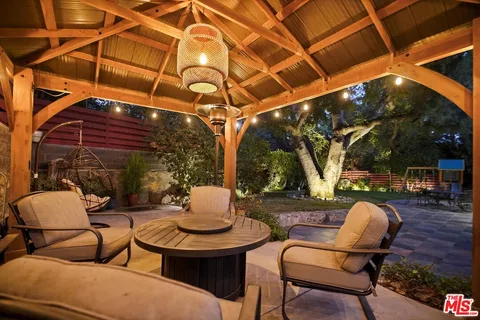 a patio with a yard table and chairs