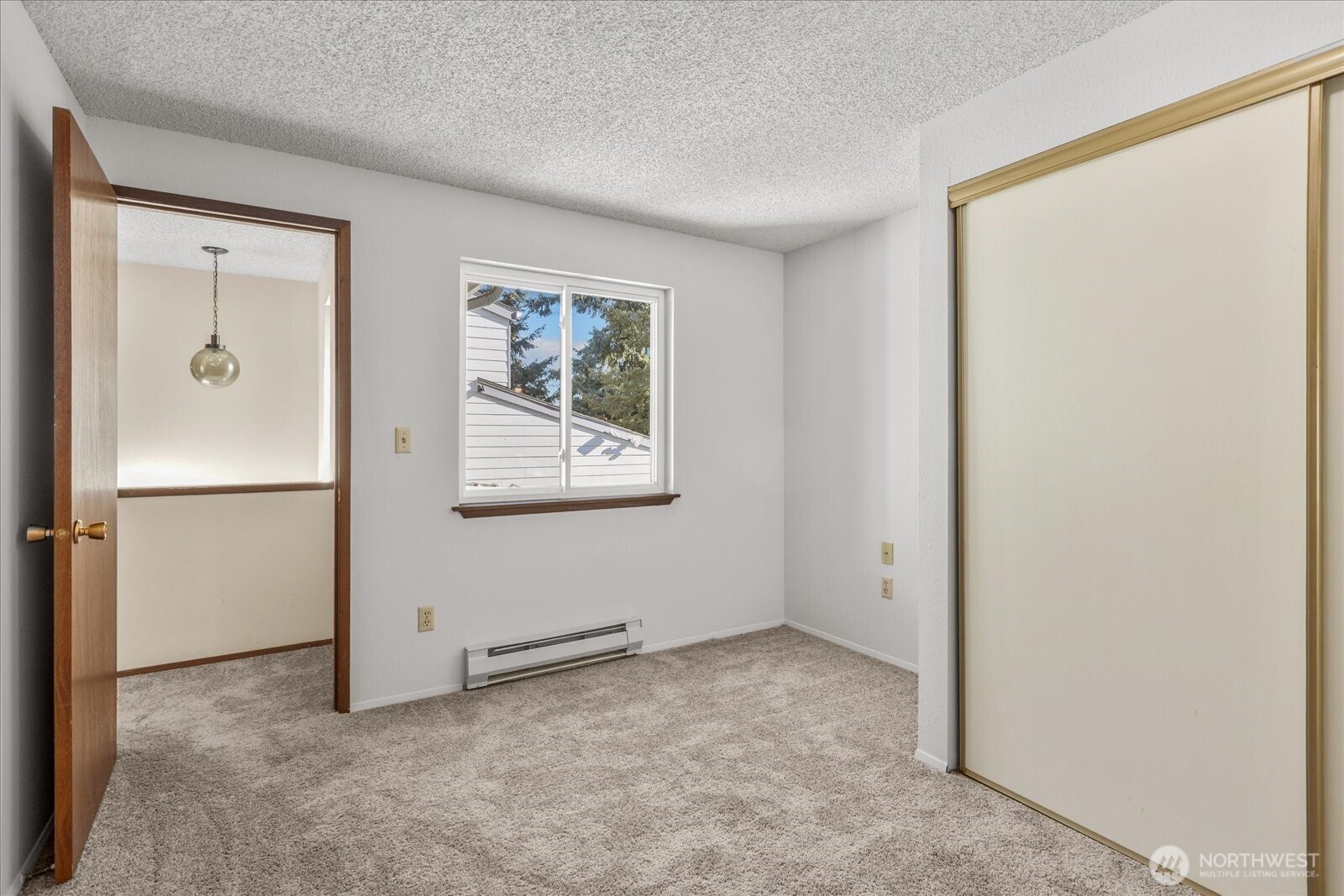 15914 3rd Place Southwest, Unit C Burien, WA 98166 - Photo 19 of 34 a view of an empty room with closet and a window