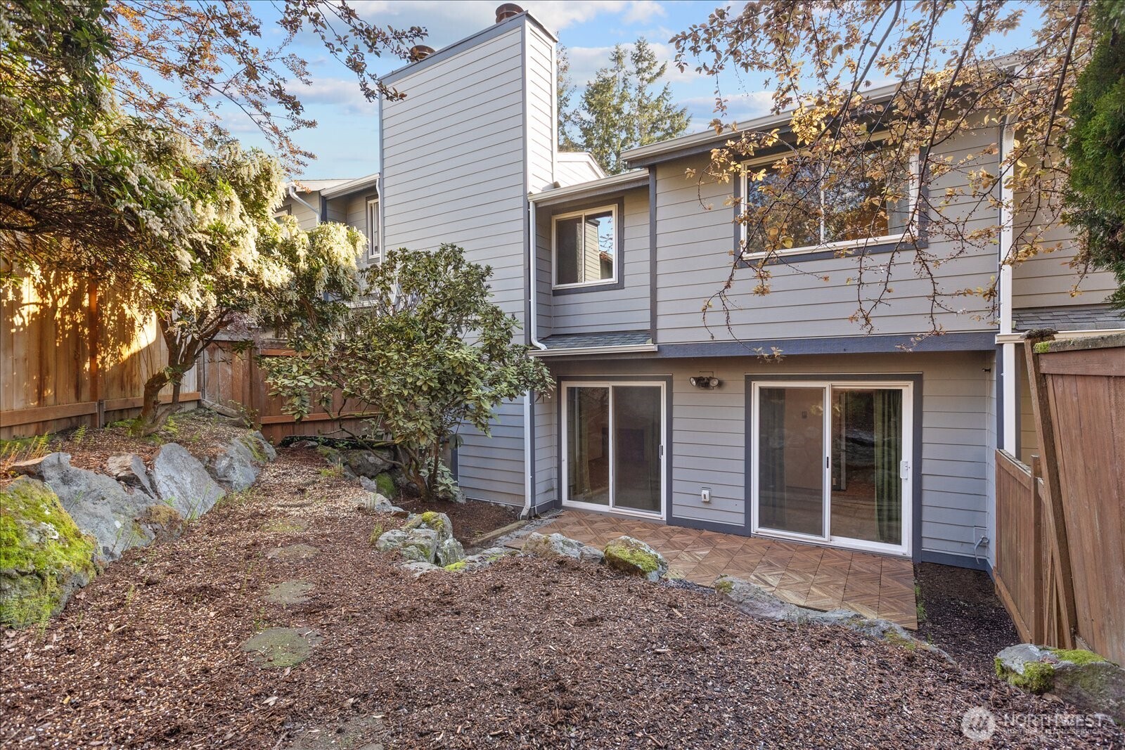 15914 3rd Place Southwest, Unit C Burien, WA 98166 - Photo 31 of 34 a view of a house with a yard and large tree