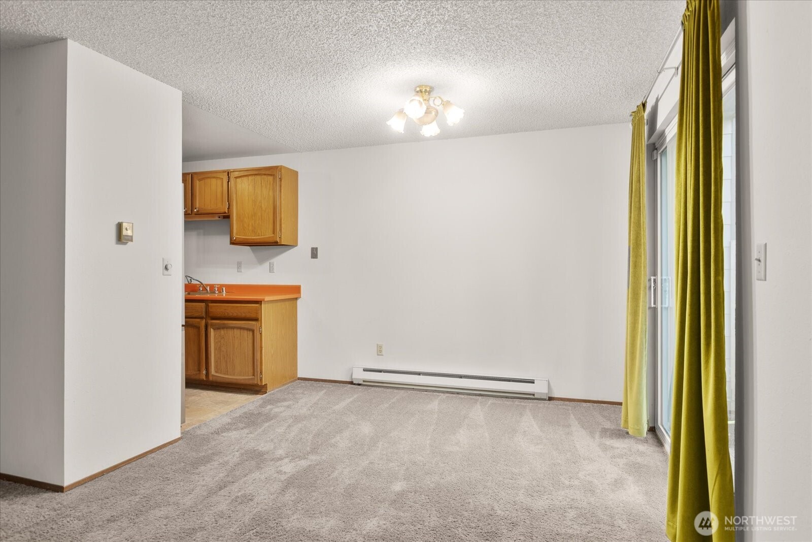 15914 3rd Place Southwest, Unit C Burien, WA 98166 - Photo 8 of 34 a view of a kitchen with a sink and a refrigerator
