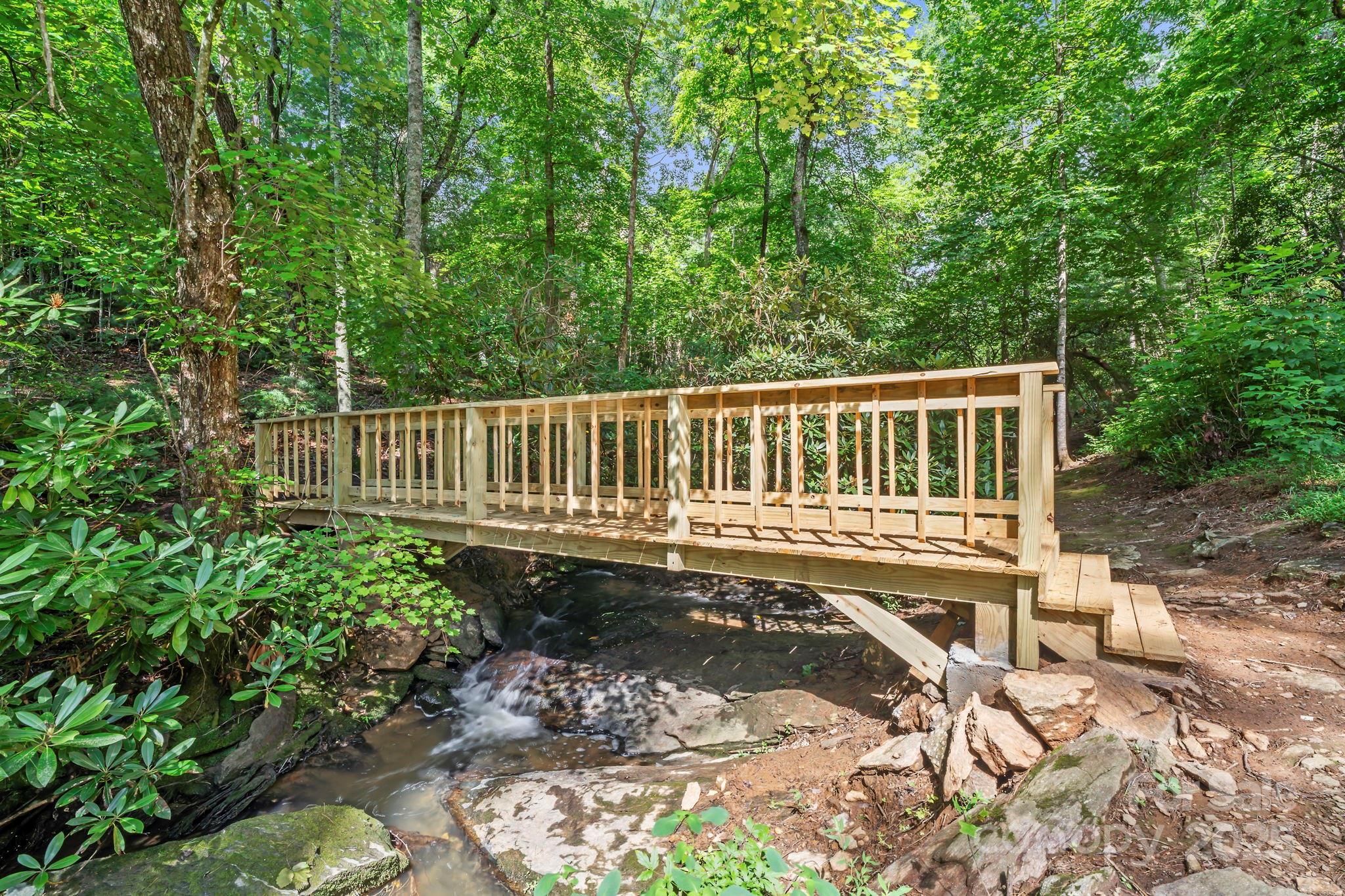 52 Dividing Ridge Trail Arden, NC 28704 - Photo 16 of 19 a view of a wooden deck with a bench