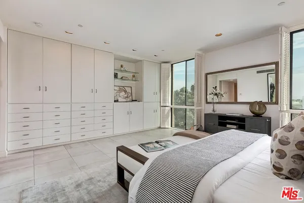 a bedroom with a bed and a cabinets