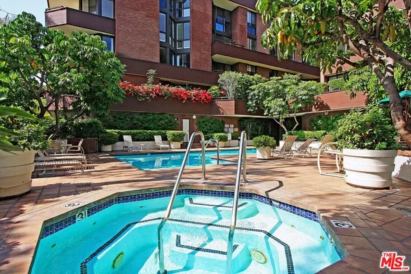 a view of a backyard with a patio and potted plants