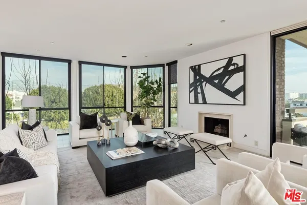 a living room with furniture large window and outer view