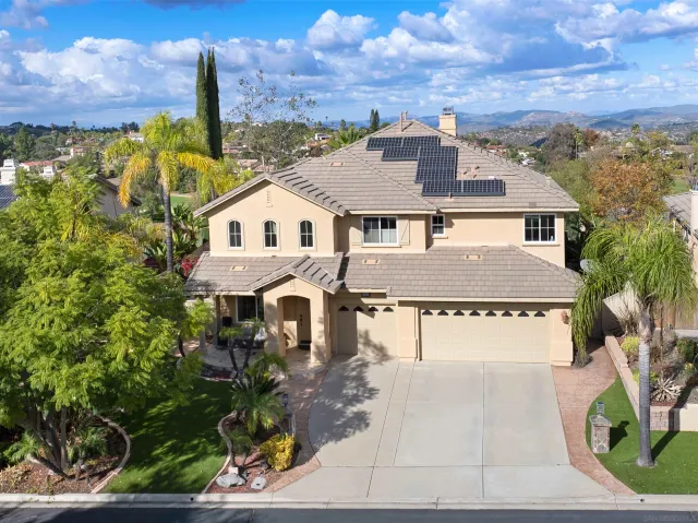 a aerial view of a house with a yard and table and chairs