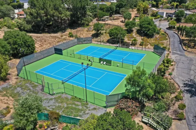 an aerial view of a house with swimming pool patio and outdoor seating
