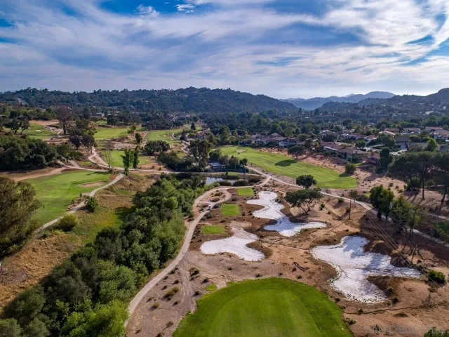 an aerial view of residential houses with outdoor space and river