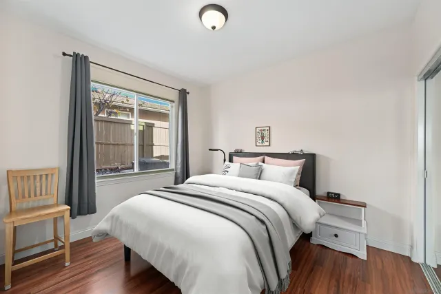 a bedroom with a bed and a large window