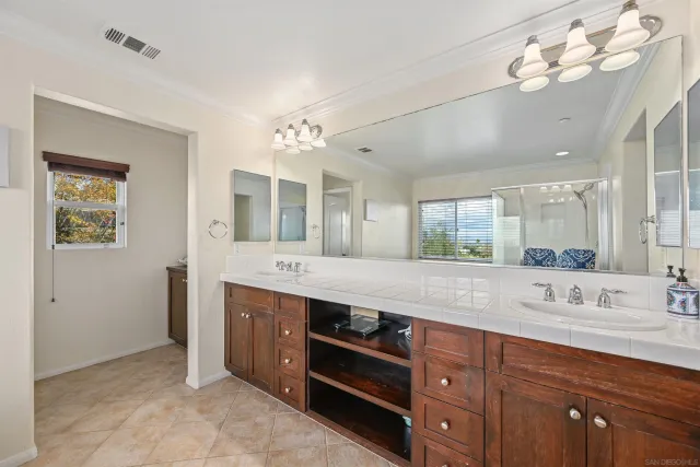 a spacious bathroom with a double vanity sink mirror and double