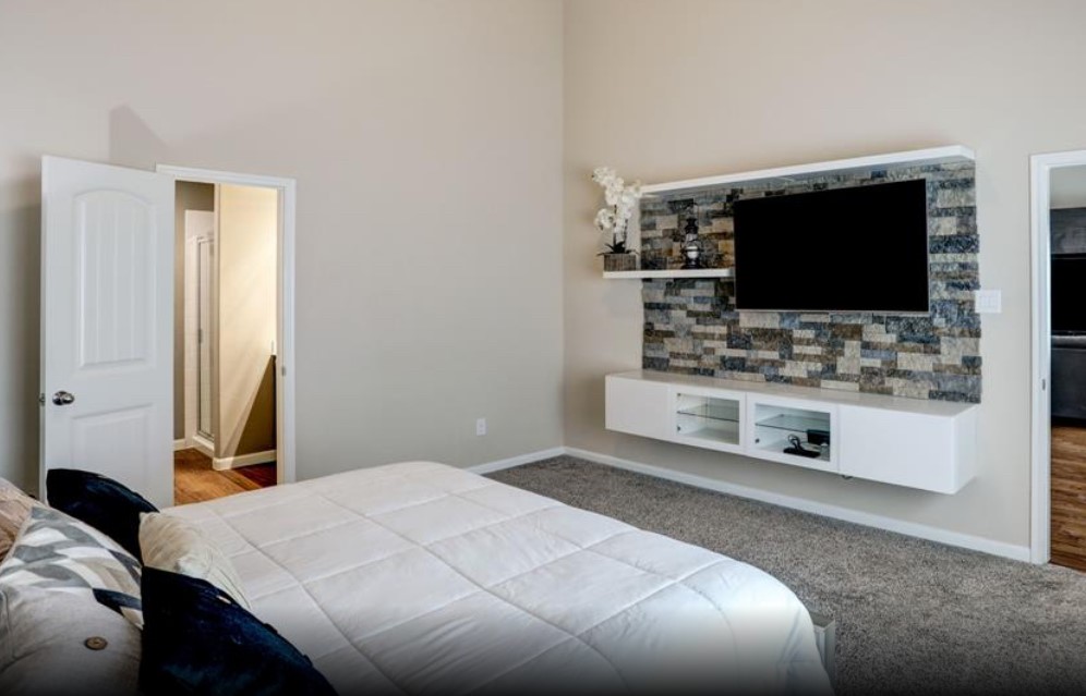 1 Rodeo Bend Drive Manvel, TX 77578 - Photo 12 of 22 a bedroom with a bed and a flat screen tv