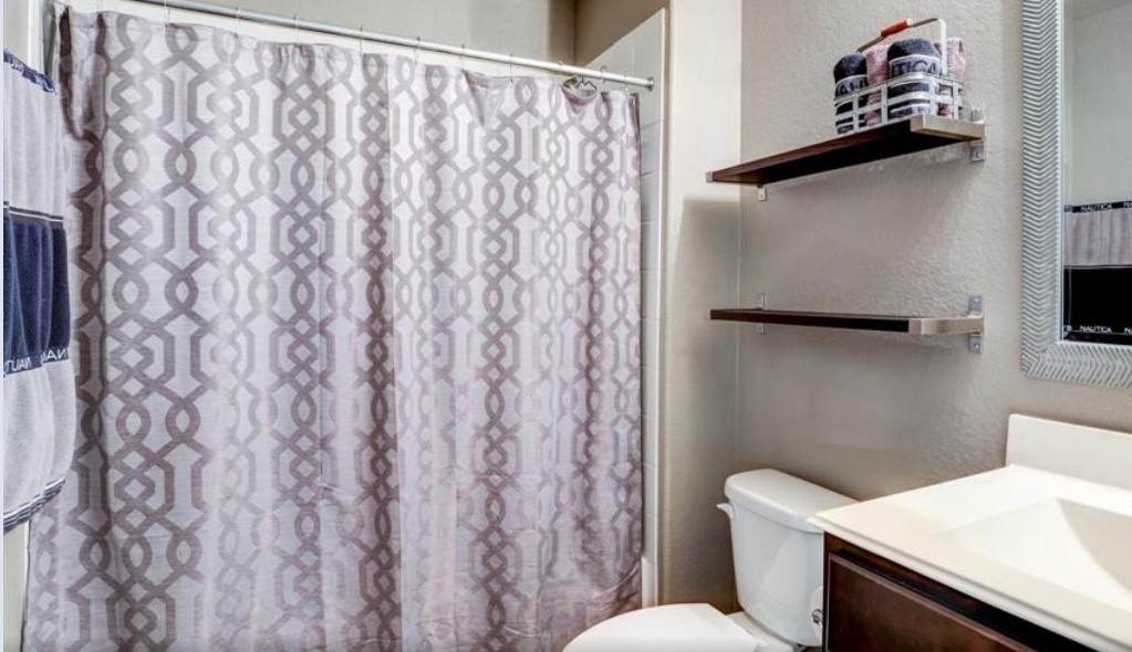 1 Rodeo Bend Drive Manvel, TX 77578 - Photo 19 of 22 a white toilet sitting next to a shower curtain