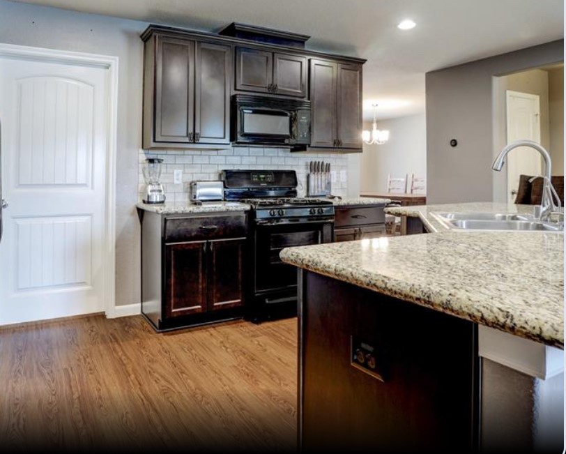 1 Rodeo Bend Drive Manvel, TX 77578 - Photo 4 of 22 a kitchen with stainless steel appliances granite countertop a stove a sink and a microwave