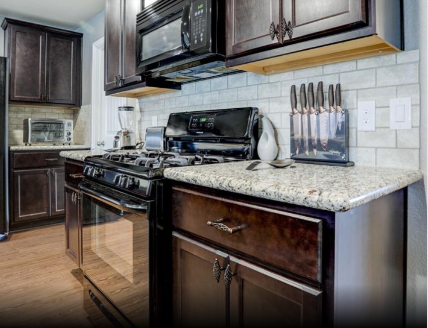 1 Rodeo Bend Drive Manvel, TX 77578 - Photo 5 of 22 a kitchen with granite countertop stainless steel appliances and cabinets