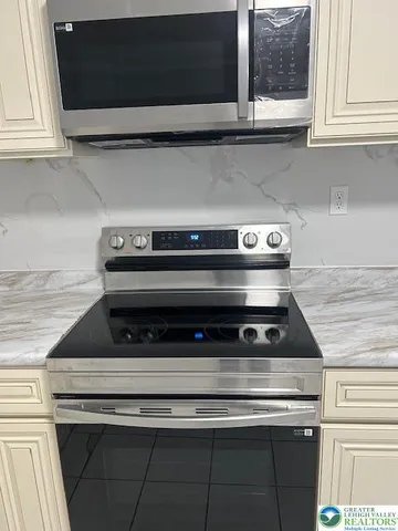 a kitchen with a stove microwave and refrigerator