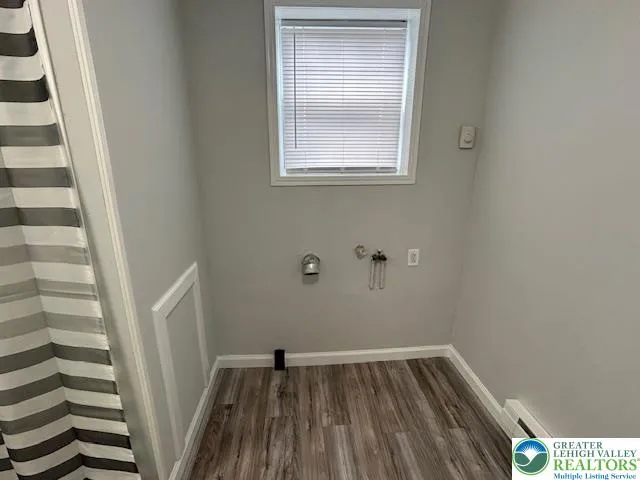 a view of a room with wooden floor and cabinet