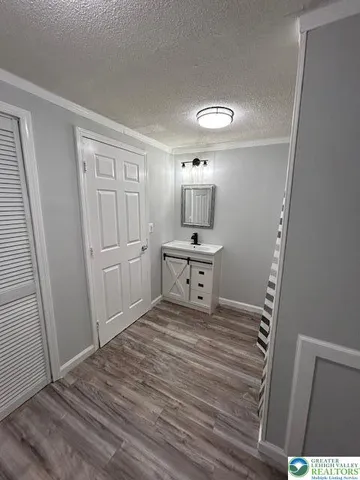 a bathroom with a sink a mirror and shower