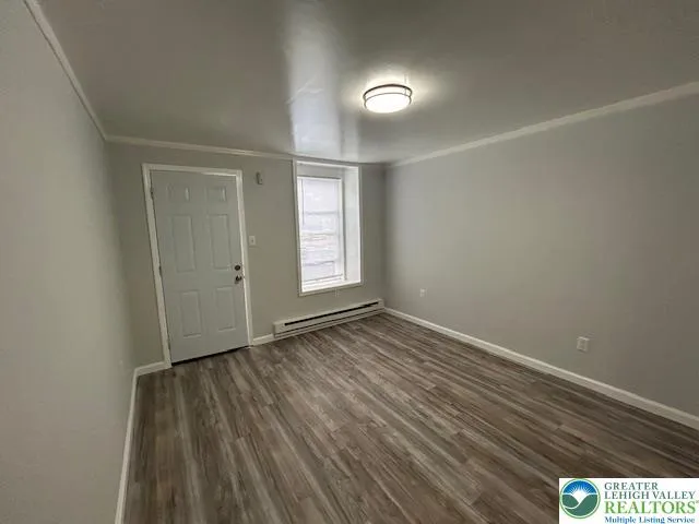a kitchen with granite countertop white cabinets and a stove top oven