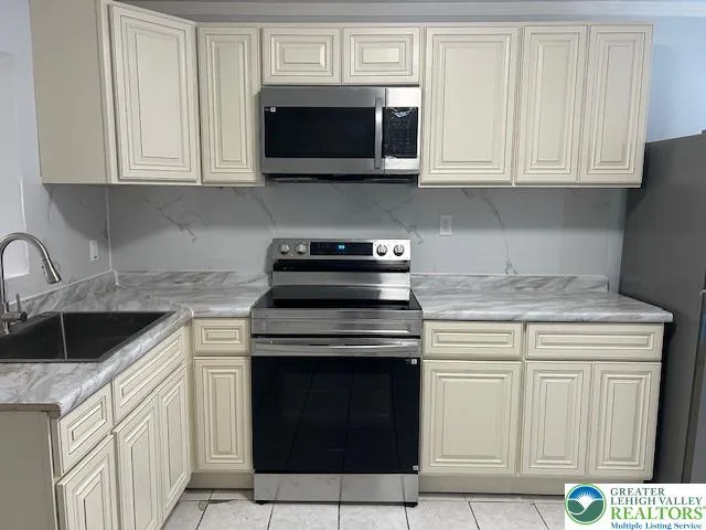 a kitchen with a sink stove and microwave