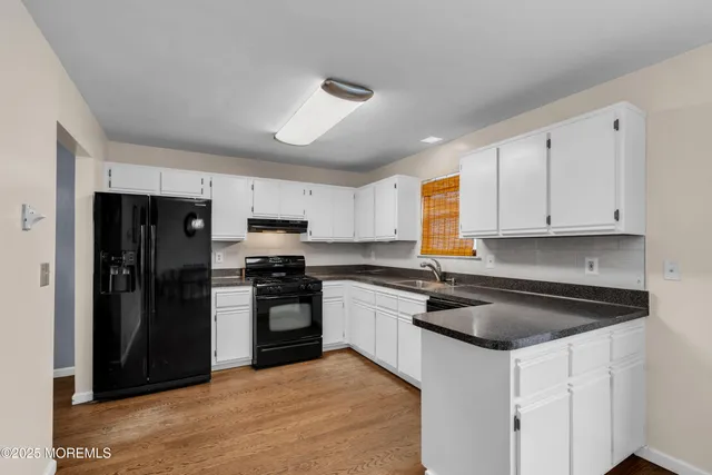 a kitchen with a sink stove and refrigerator