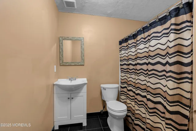 a bathroom with a toilet and a sink