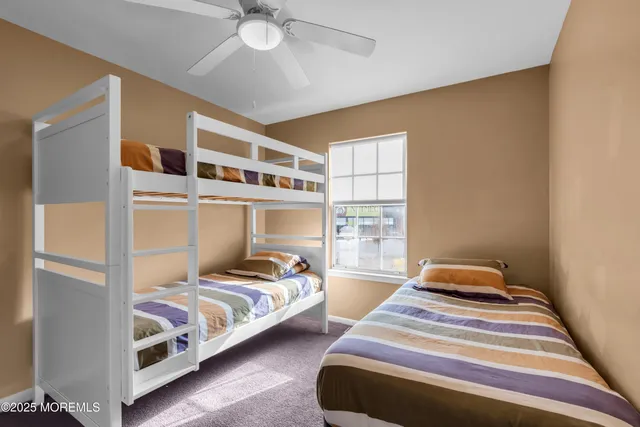 a bedroom with two beds and painted walls