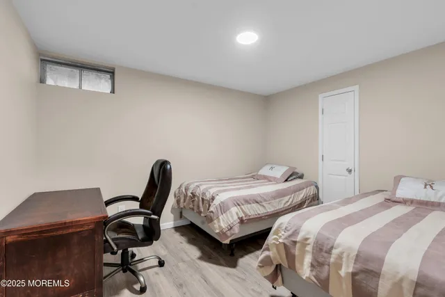 a bedroom with two beds and a desk