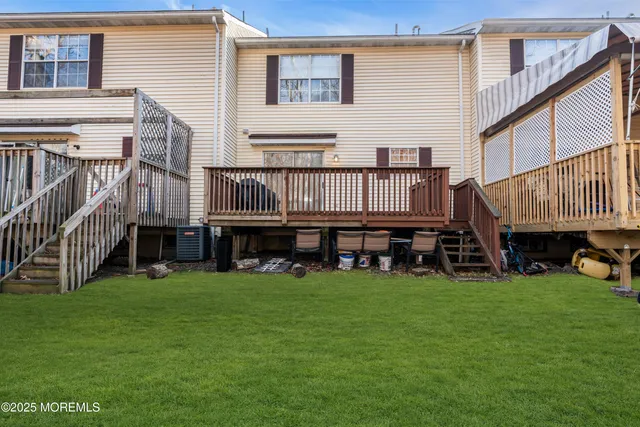a view of a house with a backyard and a tub