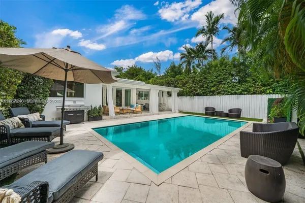a view of a backyard with furniture and a table