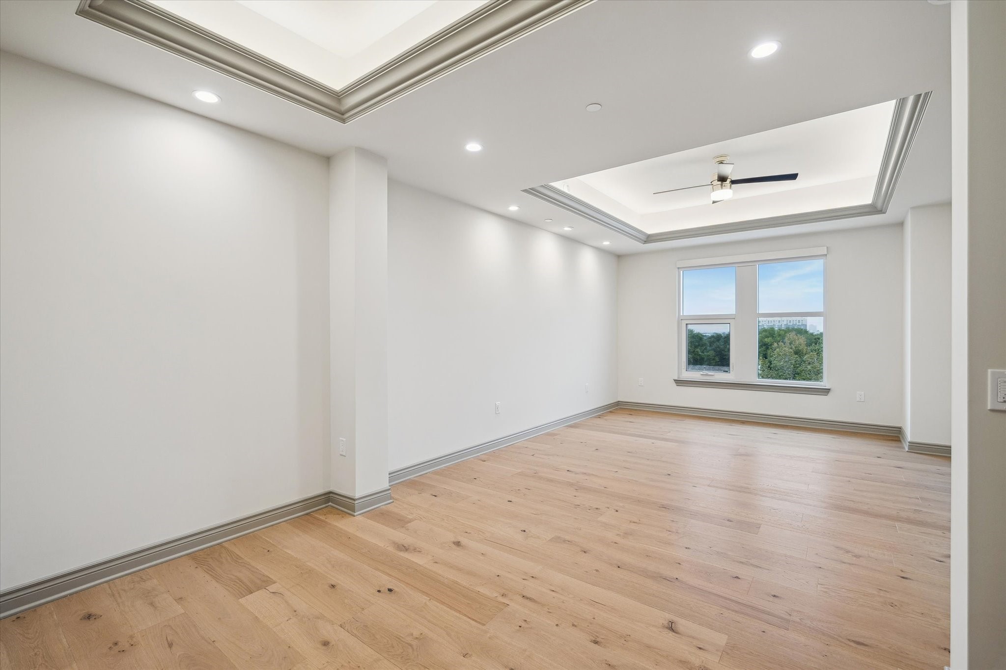 1717 Bissonnet Street, Unit 1101 Houston, TX 77005 - Photo 12 of 34 a view of an empty room with a window and wooden floor