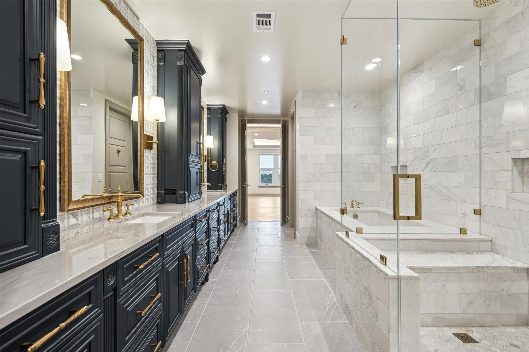 1717 Bissonnet Street, Unit 1101 Houston, TX 77005 - Photo 14 of 34 a bathroom with double vanity sinks a large mirror and a shower