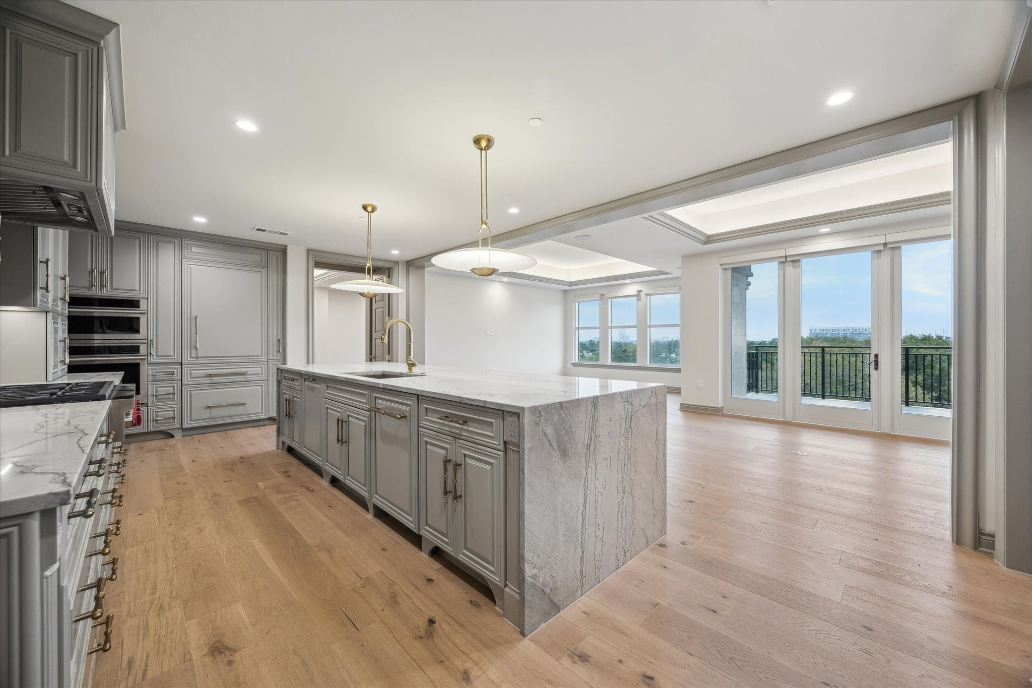 1717 Bissonnet Street, Unit 1101 Houston, TX 77005 - Photo 3 of 34 a large kitchen with stainless steel appliances a large counter top and a wooden floors