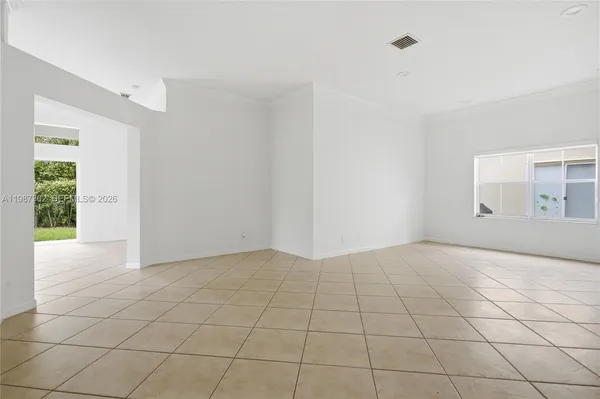 an empty room with floor to ceiling windows and an outdoor view