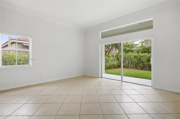 a view of a kitchen with wooden floor and a window