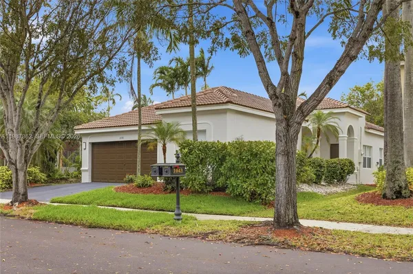 a view of a house with a tree in front of it