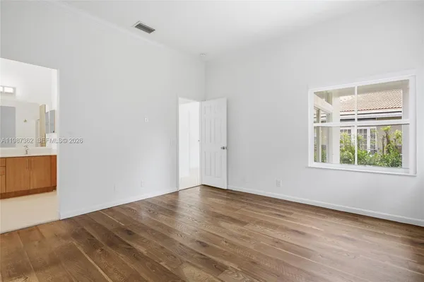 a bathroom with a double vanity sink a mirror and a bathtub