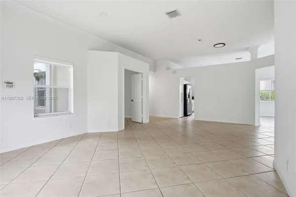 an empty room with closet and mirror