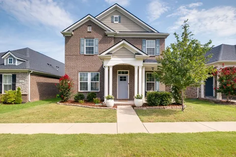 a front view of a house with a yard