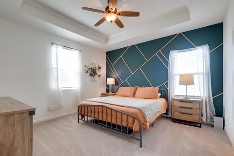 a bedroom with a bed and a chandelier