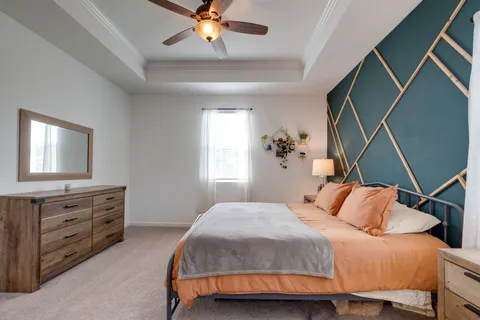 a bedroom with a bed and a chandelier