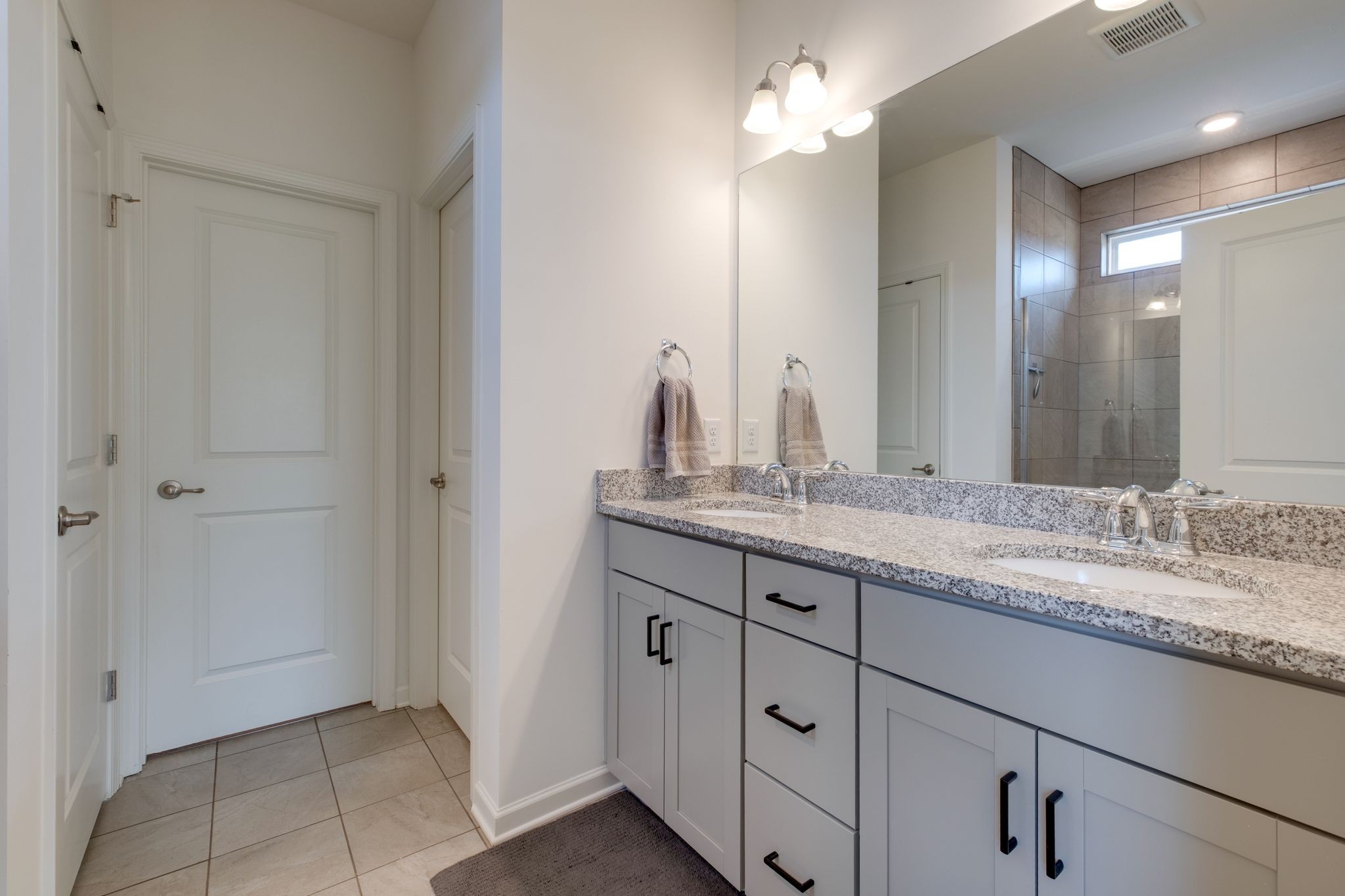 3611 Hoggett Ford Road Hermitage, TN 37076 - Photo 14 of 34 a bathroom with a granite countertop sink two mirror and a vanity