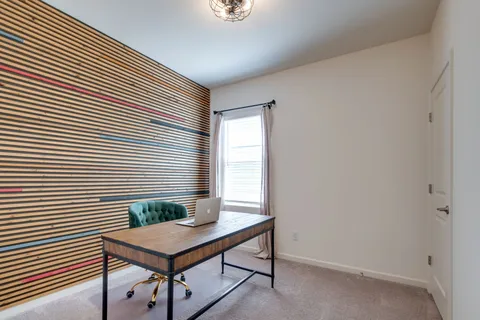 a view of a room with a table and chairs