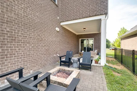 a view of a patio with table and chairs and potted plants