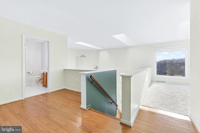 a bathroom with a granite countertop sink mirror vanity and toilet