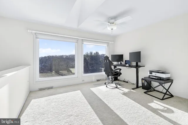 a spacious bedroom with a bed and a dresser