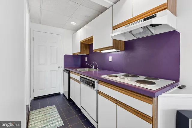 a picture of a room with a white wall and white cabinet