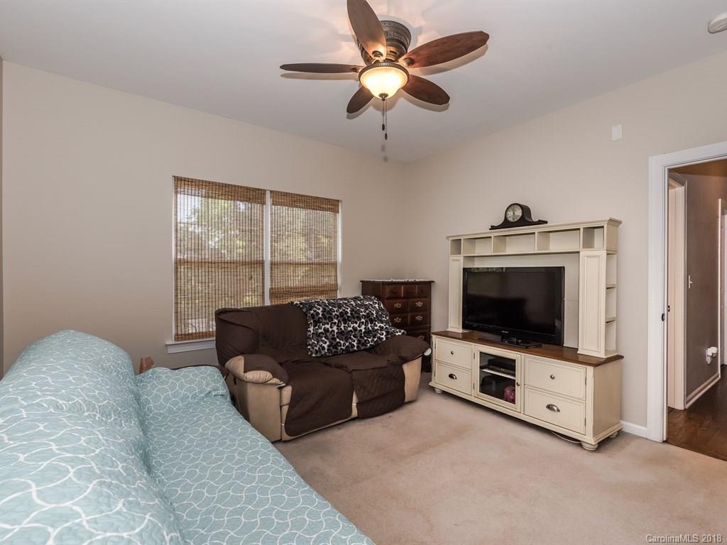 2002 Spanish Moss Road Indian Trail, NC 28079 - Photo 12 of 28 a living room with furniture and a flat screen tv