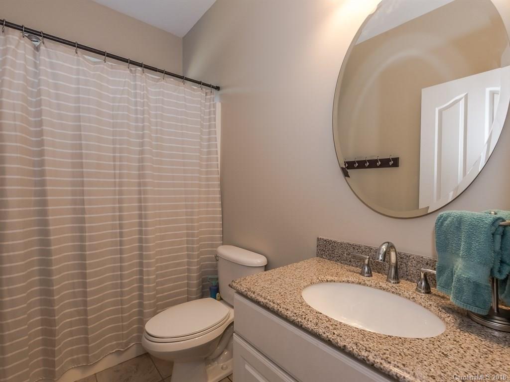 2002 Spanish Moss Road Indian Trail, NC 28079 - Photo 13 of 28 a bathroom with a granite countertop toilet sink and mirror