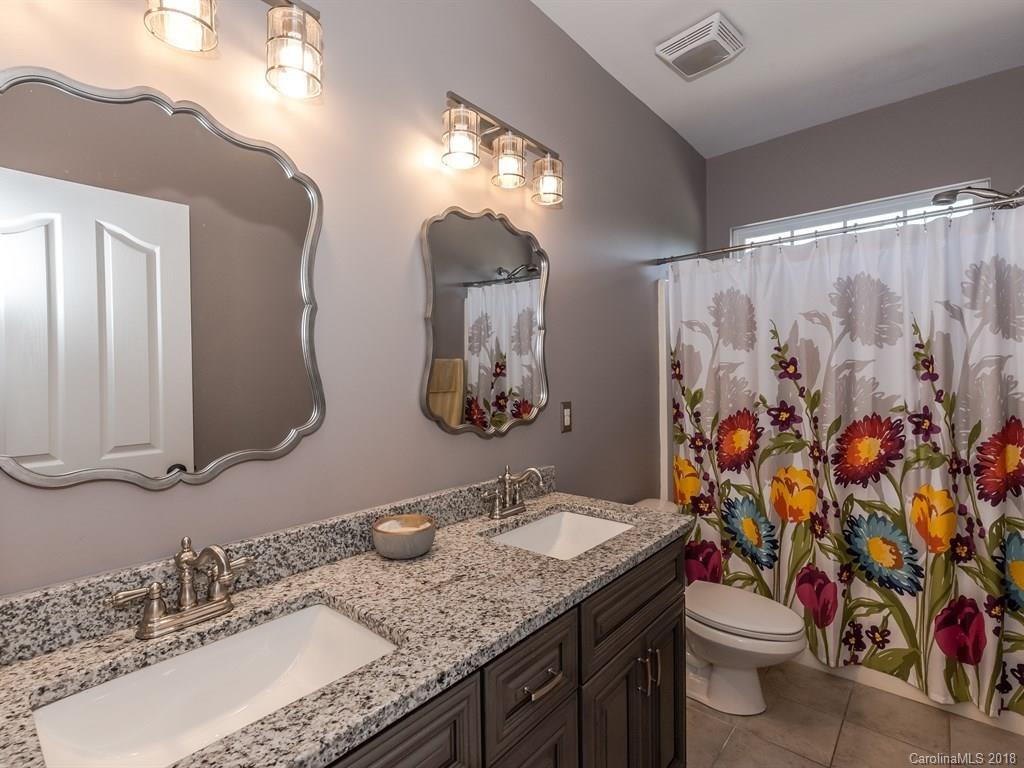 2002 Spanish Moss Road Indian Trail, NC 28079 - Photo 15 of 28 a bathroom with a granite countertop sink and a mirror