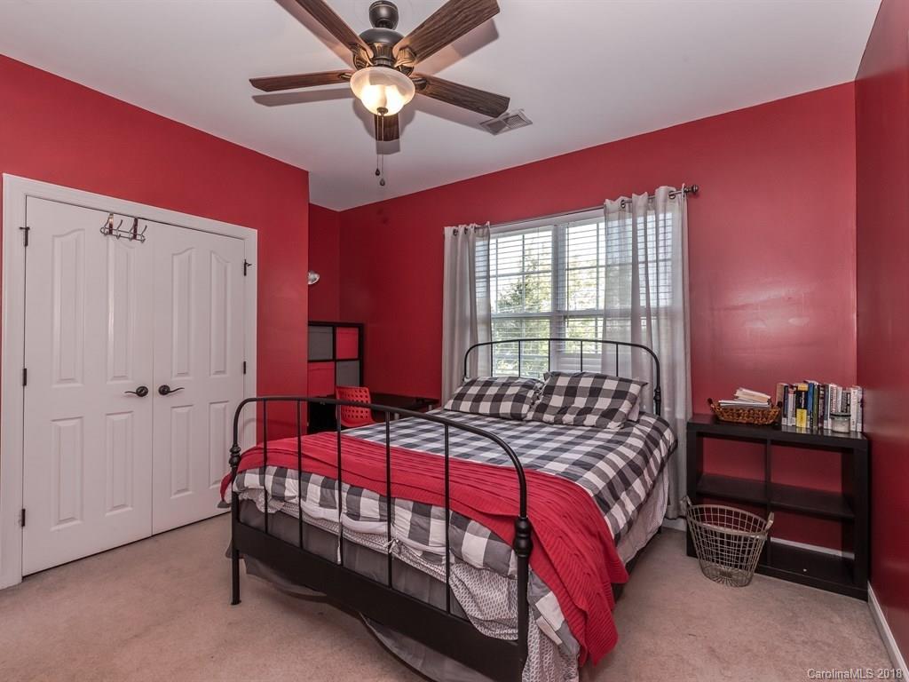 2002 Spanish Moss Road Indian Trail, NC 28079 - Photo 17 of 28 a bedroom with a bed and a chandelier