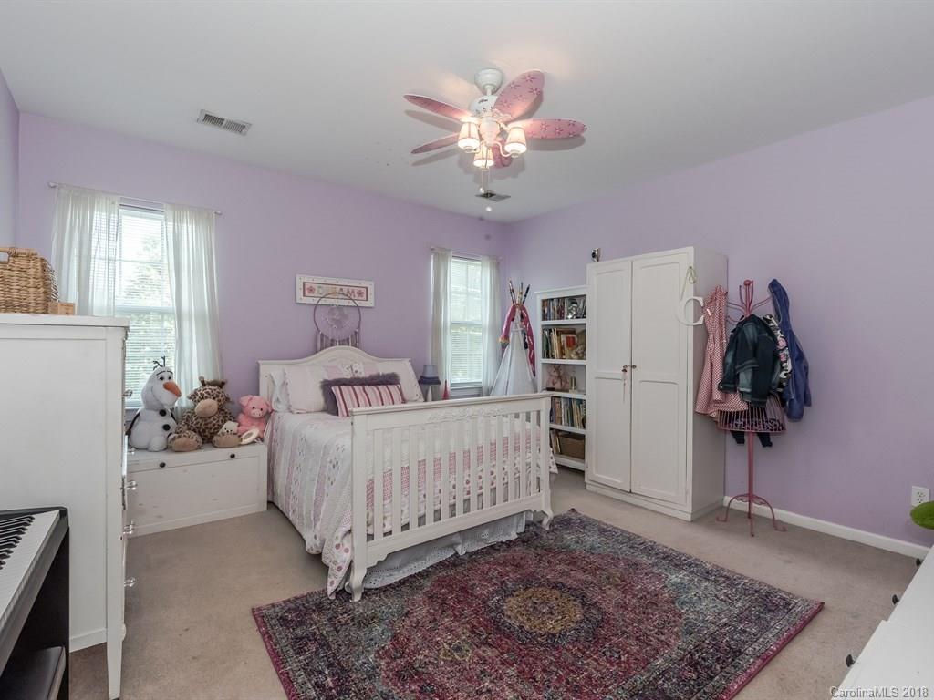 2002 Spanish Moss Road Indian Trail, NC 28079 - Photo 18 of 28 a bedroom with a bed and a chandelier
